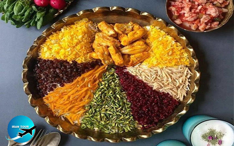 An iranian rice dish decorated with saffron - pistachio slices - almonds - barberry - orange peel and raisins